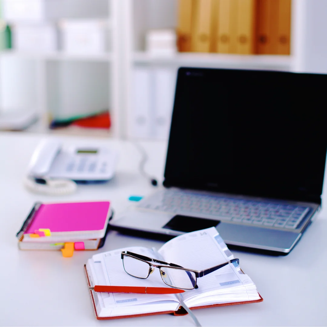 A laptop computer placed on a wooden desk, with a clean workspace surrounding it.